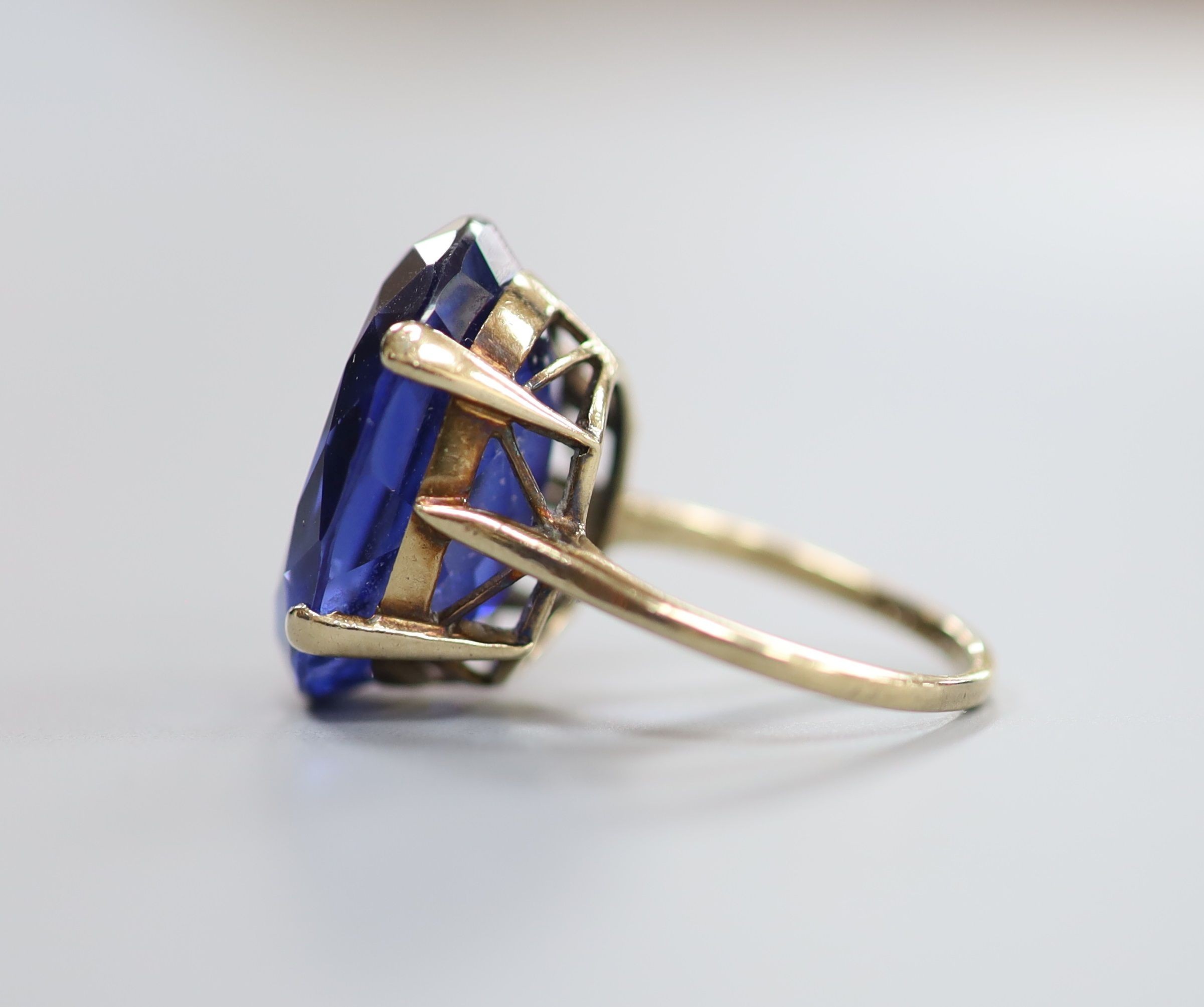 A 9ct gold and oval cut synthetic sapphire set dress ring, size L/M, gross 7.6 grams.